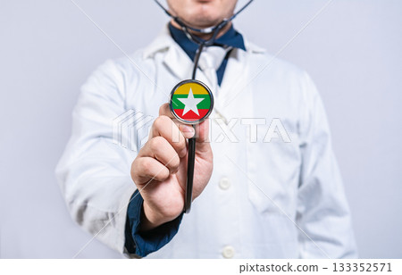 Doctor hands holding stethoscope with Myanmar flag. Myanmar health and care concept 133352571