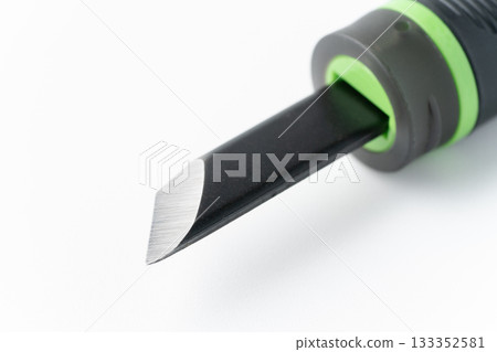 Close-up of the cutting edge of a carving knife on a white background Close-up of the cutting edge of a carving knife on a white background 133352581