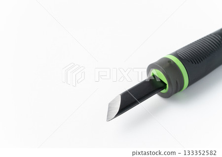 Close-up of the cutting edge of a carving knife on a white background Close-up of the cutting edge of a carving knife on a white background 133352582