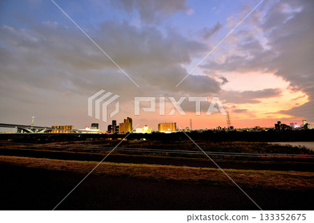 Evening view of the Toneri Liner and Ogi Ohashi Bridge from the Arakawa River bank 133352675