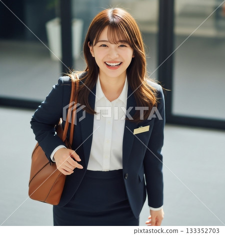 A young Japanese female employee carrying a bag 133352703