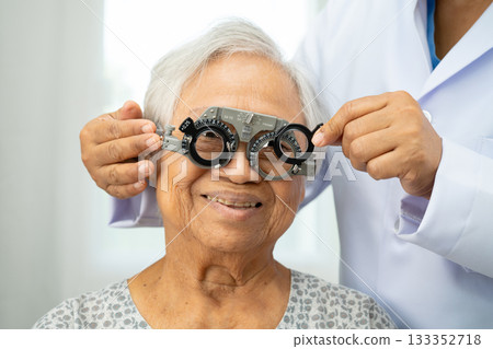 Asian senior woman wearing ophthalmic vision eye test and using optical trial frame. Asian senior woman wearing ophthalmic vision eye test and using optical trial frame. 133352718