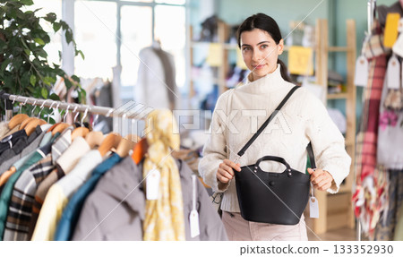 Regular customer Armenian woman chooses color and style of handbag 133352930