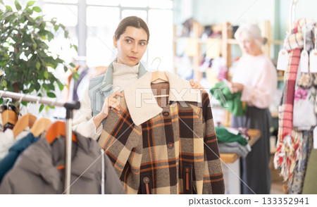 Regular customer Armenian woman chooses color and style of plaid jacket Regular customer Armenian woman chooses color and style of plaid jacket 133352941