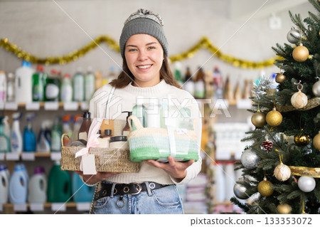 Young woman choosing gift basket in supermarket during X-mas 133353072