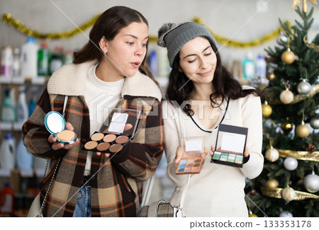 Two customers choose cosmetics for Christmas 133353178