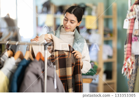Armenian woman choosing outerwear in the store Armenian woman choosing outerwear in the store 133353305