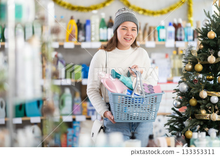 Young woman chooses household chemicals in decorated store Young woman chooses household chemicals in decorated store 133353311