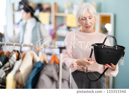 Elderly women choosing handbag in store Elderly women choosing handbag in store 133353348