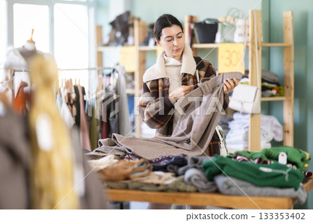 Regular customer Armenian woman chooses color and style of trousers 133353402