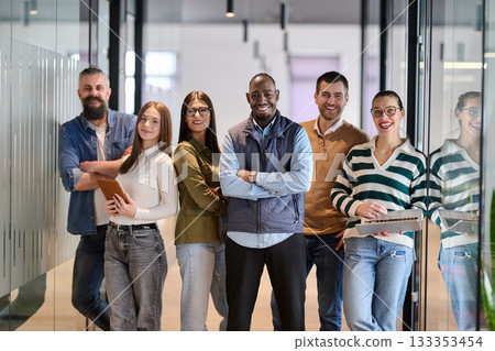 Group of confident professionals walking together through a bright modern office corridor. Concept of teamwork, diversity, success, collaboration, and positive workplace culture. 133353454