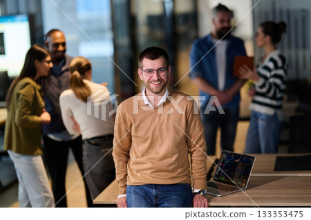 Smiling Businessman with Team Collaborating in Modern Office 133353475