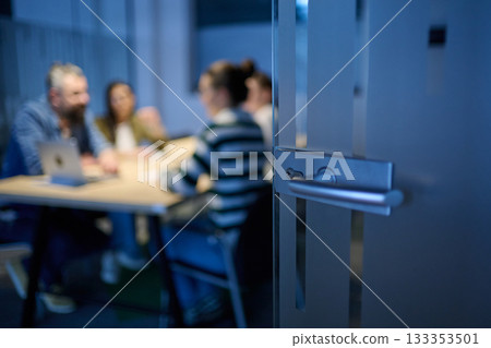 Smiling confident businessman leading a creative meeting in a modern office, symbolizing leadership, teamwork, collaboration, and success in a professional business environment. 133353501