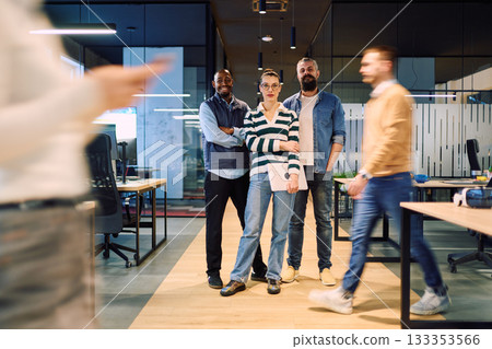 Group of confident business professionals posing together in a modern office environment, representing teamwork, diversity, leadership, and collaboration in a creative corporate setting. 133353566