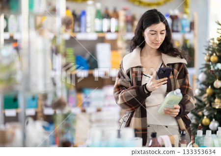 Young woman scanning qr code for dishwashing Young woman scanning qr code for dishwashing 133353634