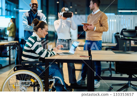Diverse business team collaborating in a modern office environment. A woman in a wheelchair works on a laptop while colleagues explore virtual reality and digital tools, promoting innovation Diverse business team collaborating in a modern office environment. A woman in a wheelchair works on a laptop while colleagues explore virtual reality and digital tools, promoting innovation 133353657