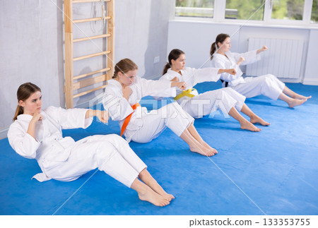 Girls in kimono doing press and kicks Girls in kimono doing press and kicks 133353755