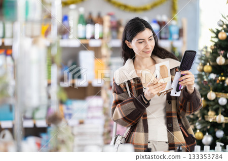 On New Year Eve, girl choose and buy hair comb 133353784