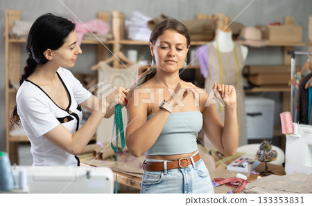 dressmaker takes measurements from the client dressmaker takes measurements from the client 133353831