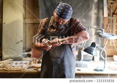 Craftsman shaping wooden toy in workshop, artisan carving wood, handmade crafts, woodworking, carpentry, hobby, small business, creative occupation, skilled labor, traditional craft Craftsman shaping wooden toy in workshop, artisan carving wood, handmade crafts, woodworking, carpentry, hobby, small business, creative occupation, skilled labor, traditional craft 133353838
