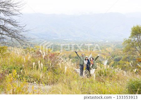 A friendly family taking a walk in nature A friendly family taking a walk in nature 133353913