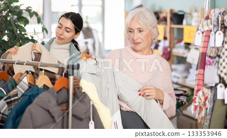 Elderly and young woman choosing coat or down jacket Elderly and young woman choosing coat or down jacket 133353946