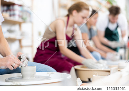 Hands of potters making a clay jug close up Hands of potters making a clay jug close up 133353961