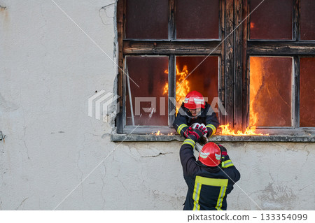 Brave firefighter rescuing a cat from a burning building, visible flames and smoke, dramatic scene, urban environment, emergency response, hero in action, saving lives Brave firefighter rescuing a cat from a burning building, visible flames and smoke, dramatic scene, urban environment, emergency response, hero in action, saving lives 133354099