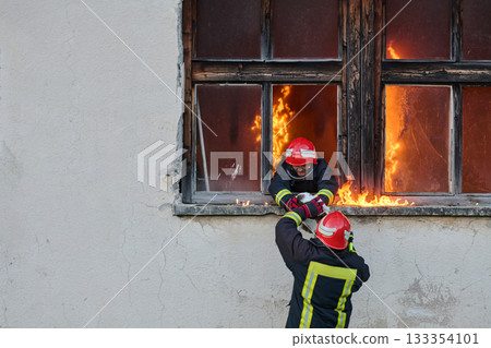 Brave firefighter rescuing a cat from a burning building, visible flames and smoke, dramatic scene, urban environment, emergency response, hero in action, saving lives Brave firefighter rescuing a cat from a burning building, visible flames and smoke, dramatic scene, urban environment, emergency response, hero in action, saving lives 133354101