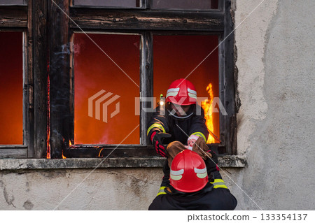 Firefighters battling flames in burning building, risking lives, firemen extinguishing blaze, emergency response, danger, rescue operation, dramatic scene, firefighters in action Firefighters battling flames in burning building, risking lives, firemen extinguishing blaze, emergency response, danger, rescue operation, dramatic scene, firefighters in action 133354137