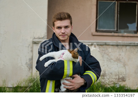 Firefighter rescues a cat from a burning building, hero holding a rescued pet, rescue operation, urban scene, firefighter in uniform, saving animal, outdoor setting Firefighter rescues a cat from a burning building, hero holding a rescued pet, rescue operation, urban scene, firefighter in uniform, saving animal, outdoor setting 133354197
