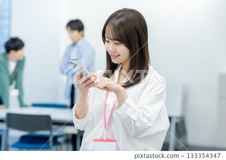 Business woman with a smartphone in the office Business woman with a smartphone in the office 133354347