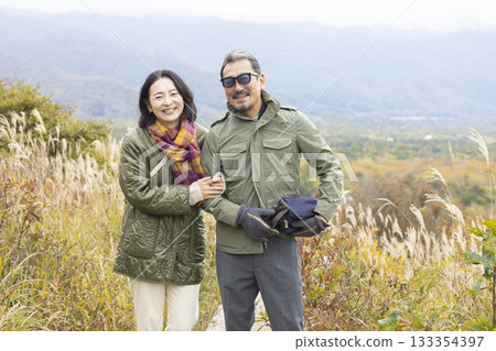 A happy couple taking a walk in nature A happy couple taking a walk in nature 133354397