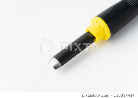 Close-up of the back of the cutting edge of a carving knife (medium round knife) on a white background 133354414