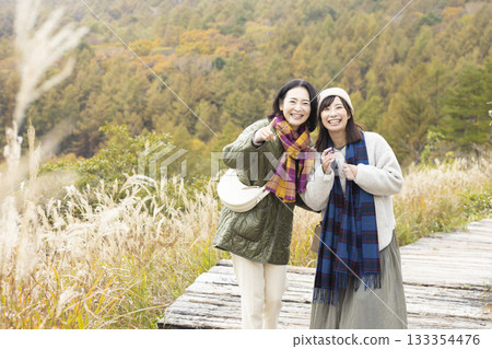 A friendly family taking a walk in nature A friendly family taking a walk in nature 133354476