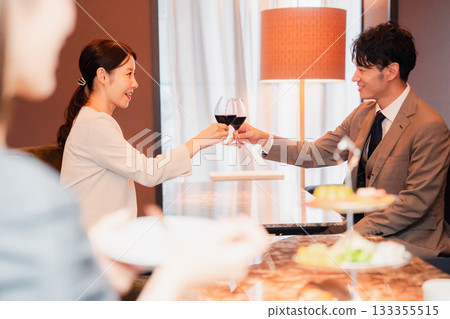 Adult men and women toasting with red wine 133355515
