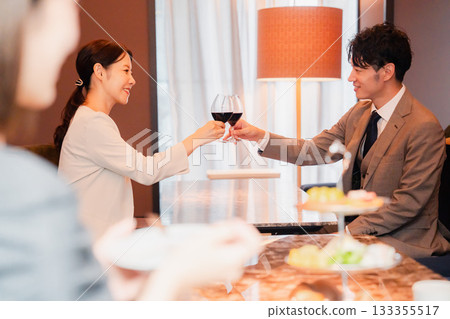 Adult men and women toasting with red wine Adult men and women toasting with red wine 133355517