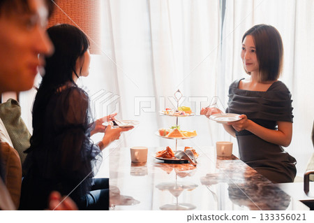Young people having a girls' get-together at a hotel afternoon tea 133356021