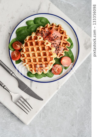 Homemade waffles with lightly salted salmon, spinach and cherry tomatoes Homemade waffles with lightly salted salmon, spinach and cherry tomatoes 133356098