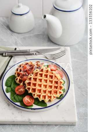Homemade waffles with lightly salted salmon, spinach and cherry tomatoes Homemade waffles with lightly salted salmon, spinach and cherry tomatoes 133356102