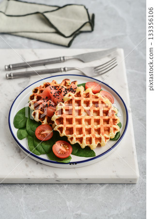 Homemade waffles with lightly salted salmon, spinach and cherry tomatoes Homemade waffles with lightly salted salmon, spinach and cherry tomatoes 133356106