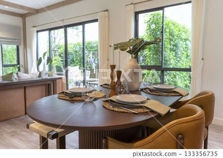 Modern dinning room interior with grey plate on wood table at home. 133356735
