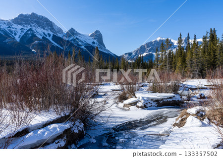 Canadian Rockies in winter, frozen river and snowy mountains. Canmore, Alberta, Canada 133357502