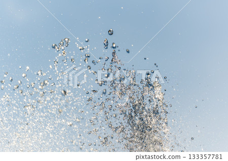 Splashes and jets of water against light background. Splashes and jets of water against light background. 133357781