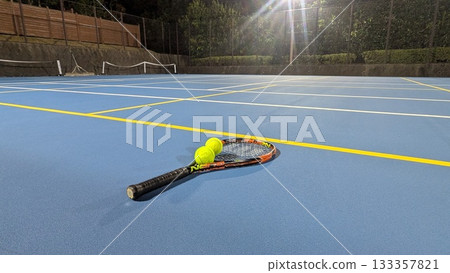 Night sports scene with tennis court and racket 133357821