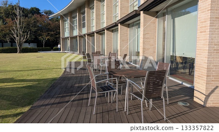 Cafe terrace and garden lit up by the autumn sky 133357822