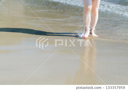Young woman walking on the seashore, white waves, clear skies, seaside, bare feet, beautiful, ideal, holiday, vacation, beach, woman Young woman walking on the seashore, white waves, clear skies, seaside, bare feet, beautiful, ideal, holiday, vacation, beach, woman 133357959