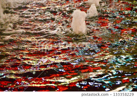 Water surface reflected by red lighting (Nishiikebukuro, Toshima-ku, Tokyo) 133358229