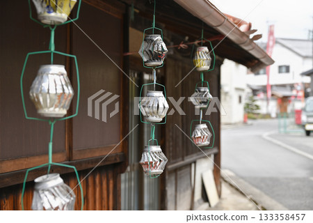 A windmill made of empty cans hanging from the eaves A windmill made of empty cans hanging from the eaves 133358457
