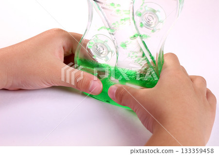Child's hand holding oil motion 133359458